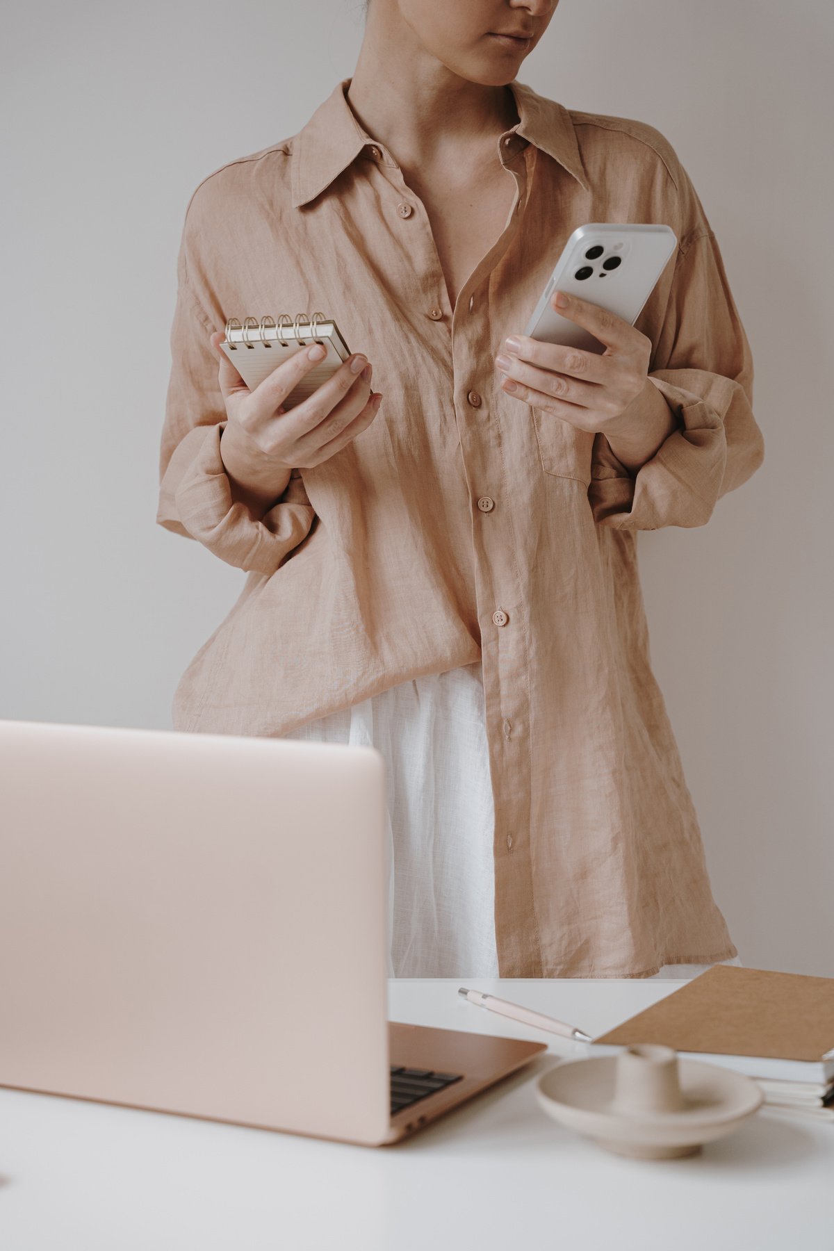 Woman Using Phone on Workspace